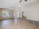 Spacious living room features tile floors, neutral walls, a vaulted ceiling, and windows with plantation shutters at 42476 W Chisholm Dr, Maricopa, AZ 85138