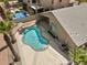 Aerial view of private backyard pool with adjacent covered patio area and lush tropical landscaping at 42476 W Chisholm Dr, Maricopa, AZ 85138