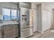 A stainless steel refrigerator in a well-lit kitchen with gray cabinetry, next to a window at 441 S Maple -- # 68, Mesa, AZ 85206