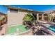 Charming backyard featuring desert landscaping, rock detail, and partial swimming pool view at 44215 W Granite Dr, Maricopa, AZ 85139