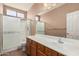 Bathroom with a glass-door shower and a vanity with a mirror at 44215 W Granite Dr, Maricopa, AZ 85139