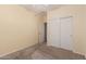 This bedroom features a ceiling fan, a closet with sliding doors, and carpeted floors at 44215 W Granite Dr, Maricopa, AZ 85139