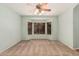 Light-filled bedroom with cozy carpet, large bay window, ceiling fan, and soft, neutral wall color at 44215 W Granite Dr, Maricopa, AZ 85139