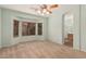 Spacious bedroom with large bay window offering natural light, carpet flooring and ceiling fan at 44215 W Granite Dr, Maricopa, AZ 85139