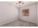 Neutral bedroom features a ceiling fan and a window with wooden blinds at 44215 W Granite Dr, Maricopa, AZ 85139