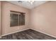 Cozy bedroom featuring hardwood floors, neutral paint, and a ceiling fan at 44215 W Granite Dr, Maricopa, AZ 85139