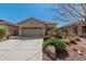 Charming single-story home with desert landscaping and a spacious two-car garage at 44215 W Granite Dr, Maricopa, AZ 85139