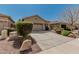 Lovely single-story home with mature landscaping and an attached two-car garage at 44215 W Granite Dr, Maricopa, AZ 85139