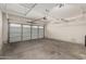 Spacious garage with overhead storage and a large garage door at 44215 W Granite Dr, Maricopa, AZ 85139