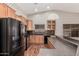 Well-lit kitchen featuring stainless appliances, wood cabinets, laminate countertops and eat-in counter space at 44215 W Granite Dr, Maricopa, AZ 85139