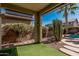 Covered patio area with artificial turf and desert landscaping at 44215 W Granite Dr, Maricopa, AZ 85139