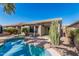 Inviting backyard pool with desert landscaping and views of the home's exterior at 44215 W Granite Dr, Maricopa, AZ 85139