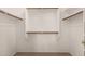 The walk-in closet features neutral carpet flooring and custom wood shelving at 44215 W Granite Dr, Maricopa, AZ 85139