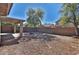 The desert landscaped backyard features a built-in firepit, covered patio, and privacy wall at 44917 W Zion Rd, Maricopa, AZ 85139