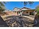 View of the private backyard featuring a built-in firepit, patio, and block wall at 44917 W Zion Rd, Maricopa, AZ 85139
