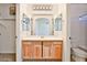 Well-lit bathroom vanity with cabinets and a large mirror at 44917 W Zion Rd, Maricopa, AZ 85139