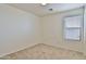Well-lit bedroom featuring carpet, a bright window, and neutral walls at 44917 W Zion Rd, Maricopa, AZ 85139