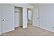 Bedroom with closet and door to the bathroom; finished with neutral carpet and paint at 44917 W Zion Rd, Maricopa, AZ 85139