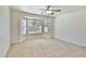 Bright bedroom with neutral carpet, ceiling fan, and large bay window offering natural light at 44917 W Zion Rd, Maricopa, AZ 85139