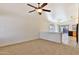 Open-concept living room with carpet flooring, a ceiling fan, and natural light at 44917 W Zion Rd, Maricopa, AZ 85139