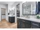 Modern bathroom with dual vanities, black cabinets, gold hardware, quartz countertops, and walk-in closets at 4606 S Ferric --, Mesa, AZ 85212