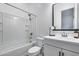 A well-lit bathroom with a shower over the tub and a modern vanity with a stylish mirror at 4606 S Ferric --, Mesa, AZ 85212