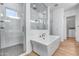 Bright bathroom featuring a freestanding tub, glass-enclosed shower, and elegant tile work at 4606 S Ferric --, Mesa, AZ 85212