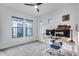 Bedroom featuring plush carpet, a ceiling fan, three windows, and a full desk setup for productivity at 4606 S Ferric --, Mesa, AZ 85212