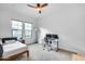 Bedroom featuring plush carpet, a ceiling fan, two windows, and a full desk set up for productivity at 4606 S Ferric --, Mesa, AZ 85212