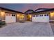 Charming exterior elevation featuring a large driveway and three-car garage at 4606 S Ferric --, Mesa, AZ 85212