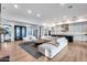 Open-concept living area with a large sectional, modern furnishings, and hardwood floors at 4606 S Ferric --, Mesa, AZ 85212