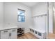 Bright mud room featuring storage bench, hooks, and storage cabinets, and wood floors at 4606 S Ferric --, Mesa, AZ 85212