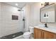 Modern bathroom featuring black hardware, tiled shower, and wood vanity at 5431 W Sierra St, Glendale, AZ 85304