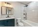 Modern bathroom featuring tiled shower over tub, updated vanity, and sleek fixtures offers luxury at 5431 W Sierra St, Glendale, AZ 85304