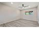 Neutral bedroom with gray floors and a window showing greenery at 5431 W Sierra St, Glendale, AZ 85304