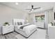 Staged bedroom with white furniture, gray floors, and window view at 5431 W Sierra St, Glendale, AZ 85304