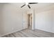 Bright bedroom with ceiling fan, wood-look floors, and a closet provides comfort and modern style at 5431 W Sierra St, Glendale, AZ 85304