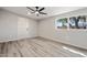 Well-lit bedroom featuring wood-look flooring, ceiling fan, and a window brings in the outdoor beauty at 5431 W Sierra St, Glendale, AZ 85304