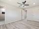 Clean bedroom with gray floors, ceiling fan, and view to tiled shower at 5431 W Sierra St, Glendale, AZ 85304