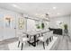 Staged dining room with white chairs and table, stylish decor, and gray floors at 5431 W Sierra St, Glendale, AZ 85304