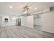 Open concept living room with modern lighting, barn door, and kitchen with stainless steel appliances at 5431 W Sierra St, Glendale, AZ 85304