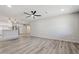 Spacious living room with gray floors, modern fan, and open view of kitchen at 5431 W Sierra St, Glendale, AZ 85304