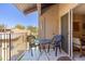 Outdoor balcony seating with a decorative table and chairs on tile patio at 5525 E Thomas Rd # N5, Phoenix, AZ 85018