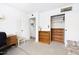 Bedroom featuring a couch, desk, chair, and shelving next to the closet at 5525 E Thomas Rd # N5, Phoenix, AZ 85018