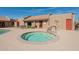 Tranquil hot tub beside the pool, a relaxing space within the residential community at 5525 E Thomas Rd # N5, Phoenix, AZ 85018