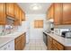Functional kitchen with white appliances and wooden cabinets at 5525 E Thomas Rd # N5, Phoenix, AZ 85018