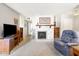 Bright living room showcasing a decorative fireplace and an armchair at 5525 E Thomas Rd # N5, Phoenix, AZ 85018