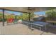 Inviting covered patio featuring ping pong, foosball, and other outdoor games, perfect for entertaining at 560 S 197Th Ave, Buckeye, AZ 85326