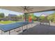 Spacious covered patio with ping pong table and backyard games in a lush, landscaped yard at 560 S 197Th Ave, Buckeye, AZ 85326