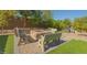 Cozy backyard with a stone-clad fire pit and seating, perfect for enjoying evenings outdoors at 560 S 197Th Ave, Buckeye, AZ 85326
